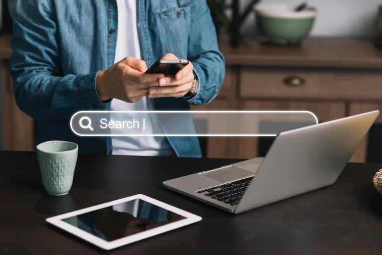 Person using mobile and laptop to manage Google Business Profile