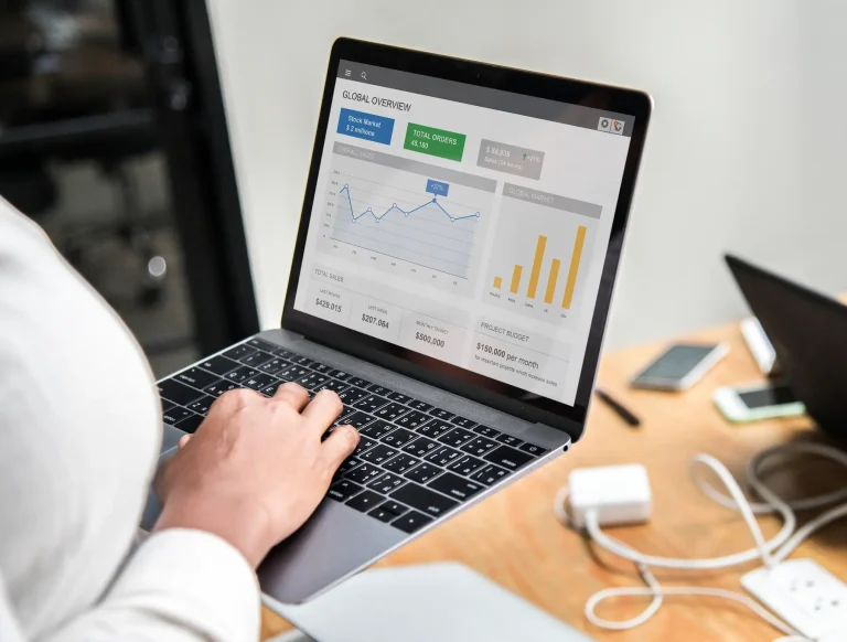 Person reviewing analytics dashboard on laptop for Google Ads management
